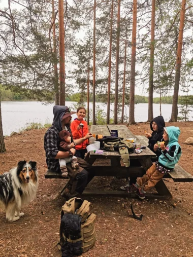 Meistä 22 perhe syö eväitä rannassa pöydän äärellä